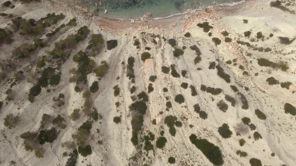 Aerial view moving from the cliffs to the mediterranean ocean.