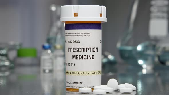 Prescription medicine bottle and pills in medical lab