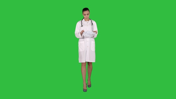 Medical doctor with stethoscope putting medical hat or
