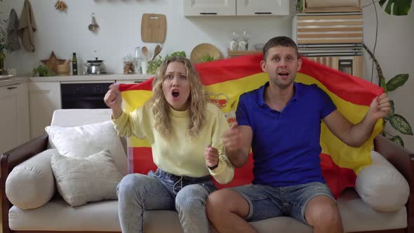 Family Couple of Football Fans at Home with Flag of Spain