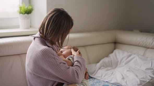 Mother Measuring Temperature of Her Ill Kid at Background