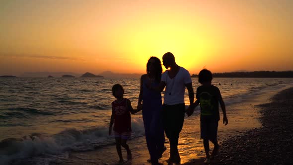 Family Walking At Sunset