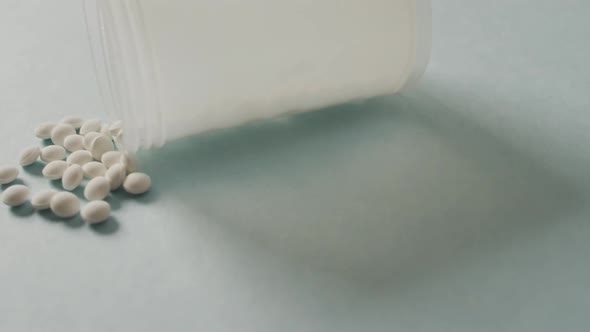 Video of close up of box of white pills on white background