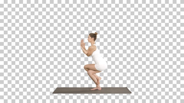 Beautiful young woman doing yoga exercise for ankles calves,