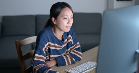 Young woman work on computer at home