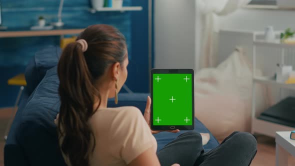 Business Woman Looking at Tablet Computer with Mock Up Green Screen Chroma Key Display