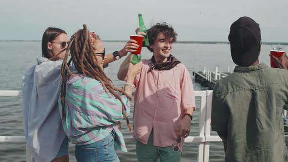 Diverse Friends Drinking on Pier