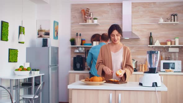 Woman Peeling Off Oranges