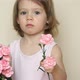 Little Girl Holds Bouquet of Flowers Pink Carnations Looks at Camera Smiles and Gives Flowers - VideoHive Item for Sale