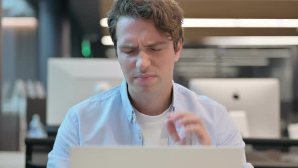 Close Up of Man Having Neck Pain While Using Laptop