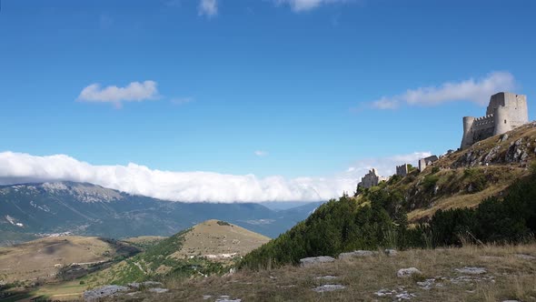 Pan of Rocca Calascio montaintop fortress and Appenines mountain range, Italy