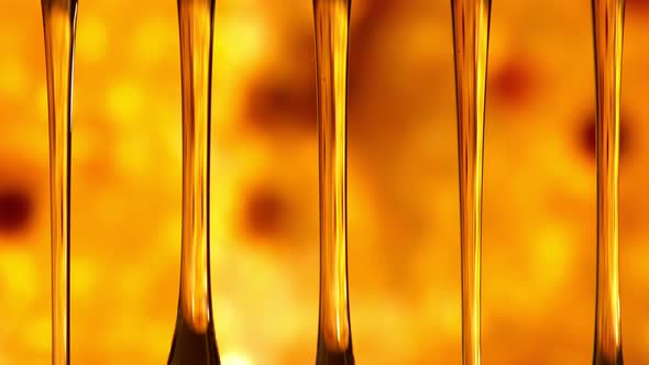 Super Slow Motion Macro Shot of Dripping Honey on Golden Honeycomb Background at 1000 Fps