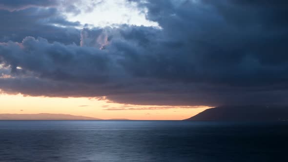 Night Coming Over Calm Sea With Clouds Above 