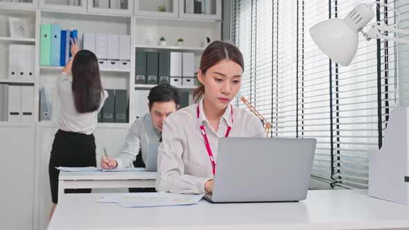 Group of Asian attractive businesspeople use laptop computer working in office workplace.