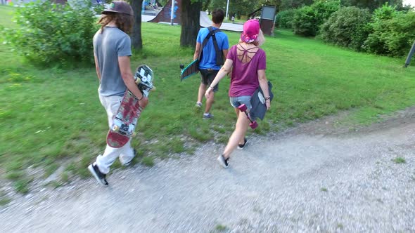 Group of three skateboarders going to skatepark