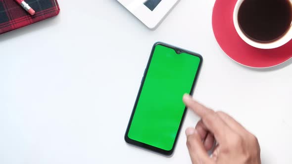 Top View of Man Hand Using Smart Phone on Office Desk 