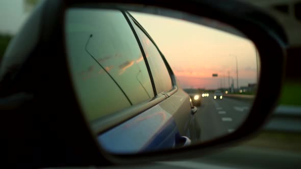 Reflection of the Road in the Rearview Mirror