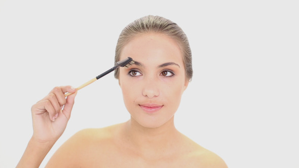 Beautiful Model Using An Eyebrow Brush