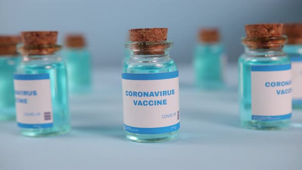 COVID19 Vaccine Concept Doctor Hold in Glove Takes Vial of Coronavirus Vaccine