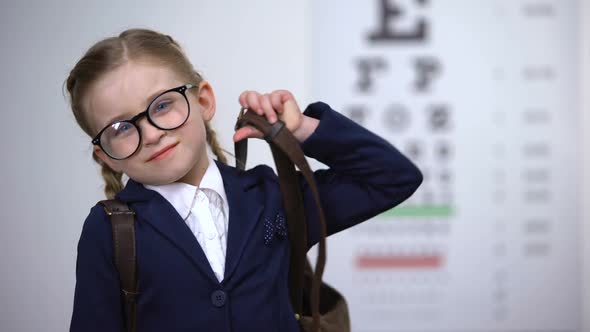 Pretty Schoolgirl in Glasses Smile, Awareness of Complete Eye Exam Before School