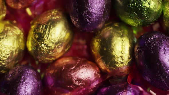 Rotating shot of colorful Easter candies on a bed of easter grass