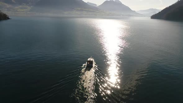 Aerial video of a boat cruising on lake Lucern in Switzerland