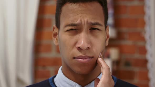 Frustrated African Man Lying in Bed Suffering Teeth Pain Toothache