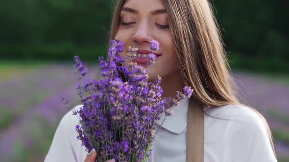 Happy Girl Collecting Lavender Flowers in Field