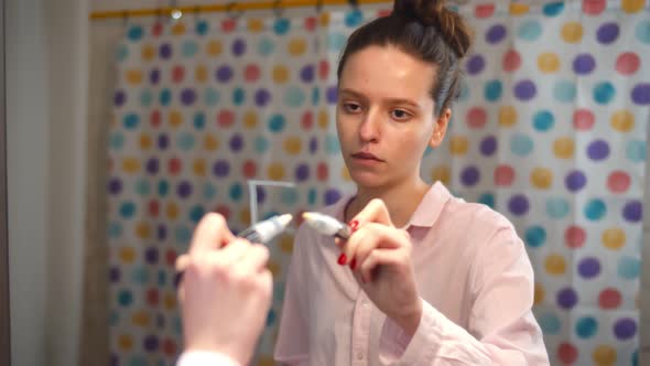 Sick Female Writing Fat Word on Mirror with White Marker