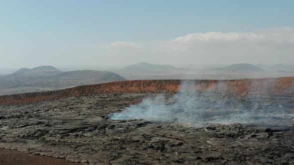 Fly Over Large Hole in Cooling Lava Layer Emitting Smoke