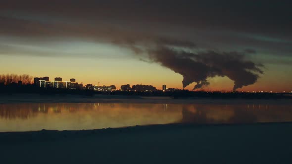 Camera Hastily Flies Over River To City Whose Air Full of Clouds of Dirty Steam.