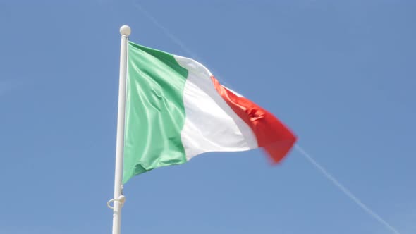 Flag of Italy flowing on wind in front of blue sky 4K 3840X2160 UltraHD footage - Italian flag outdo