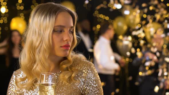 Sad Blond Woman Feeling Lonely at Party, Dancing People on Background, Offence