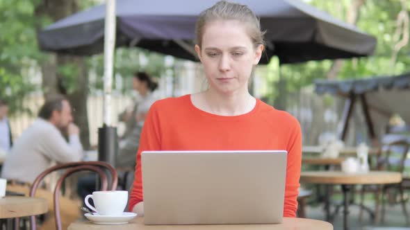 Young Woman Leaving Bench After Closing Laptop