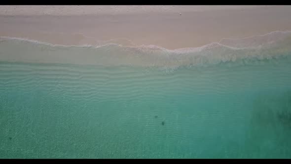 Aerial drone seascape of relaxing tourist beach adventure by blue water with white sand background o