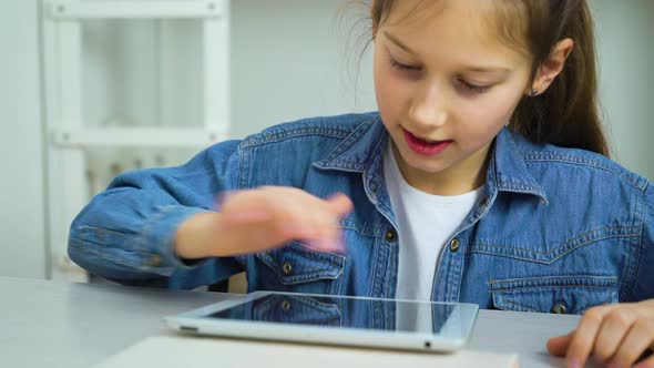 internet addiction by kid playing online games on tablet