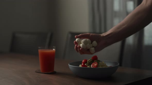 Slow Motion Add Mozzarella to Fettuccine Pasta in Blue Bowl