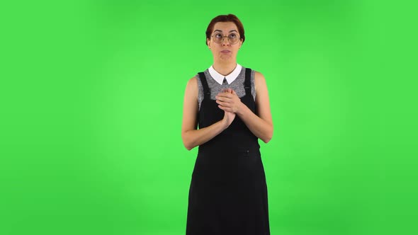 Funny Girl in Round Glasses Is Clapping Her Hands with Dissatisfaction. Green Screen