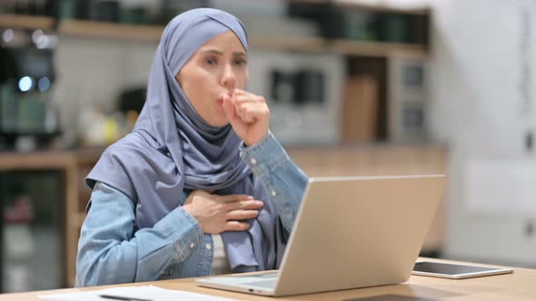 Young Arab Woman with Laptop at Work Coughing 