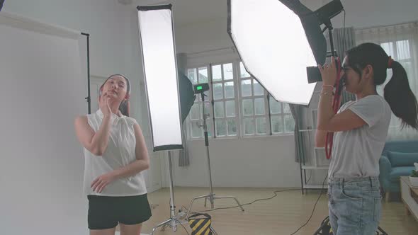 Behind The Scenes On Photo Shoot: Beautiful Asian Model Poses For A Photographer