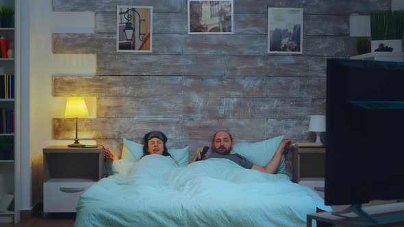 Young Couple Under the Sheets in Their Bedroom