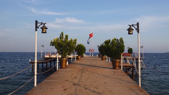 Tourists Rest on the Pier Near the Sea