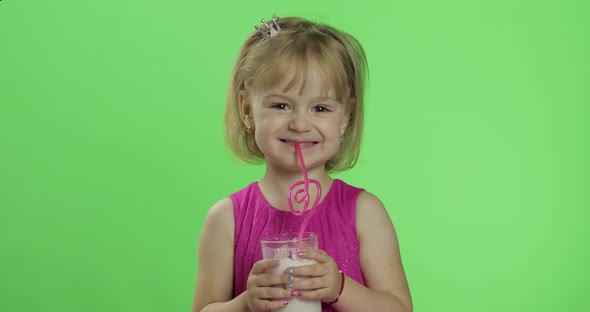 Happy Four Years Old Child in Pink Dress Drinks Milkshake Cocktail. Chroma Key