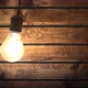 Swinging Incandescent Bulb in Timber House Darkened Room - VideoHive Item for Sale