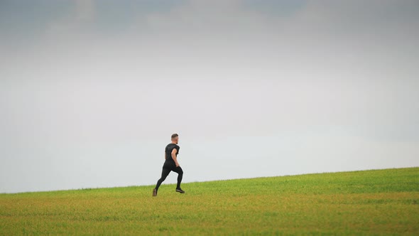 The Sportsman is Quickly Running Across the Green Grass