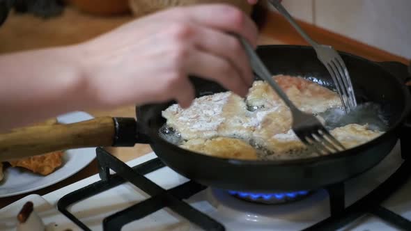 Cooking Meat Chops in a Frying Pan in the Home Kitchen. Slow Motion