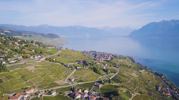 Flying high above Aran and Grandvaux village in Lavaux vineyard, Switzerland