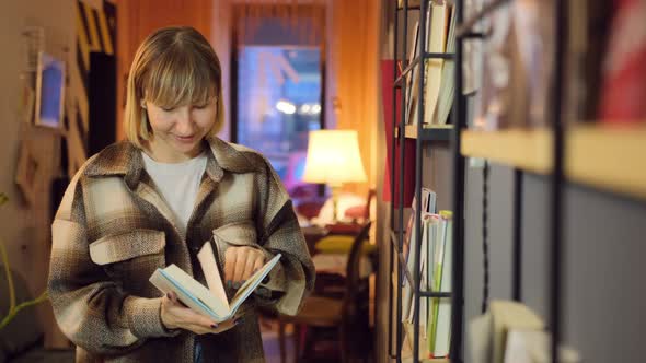 Woman Reading Book in Library