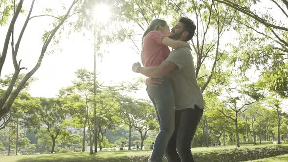 Young couple hugging in park