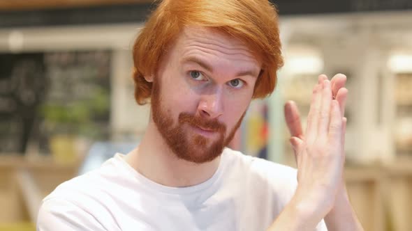 Applauding Headshot of Happy Redhead Beard Man Clapping in Cafe